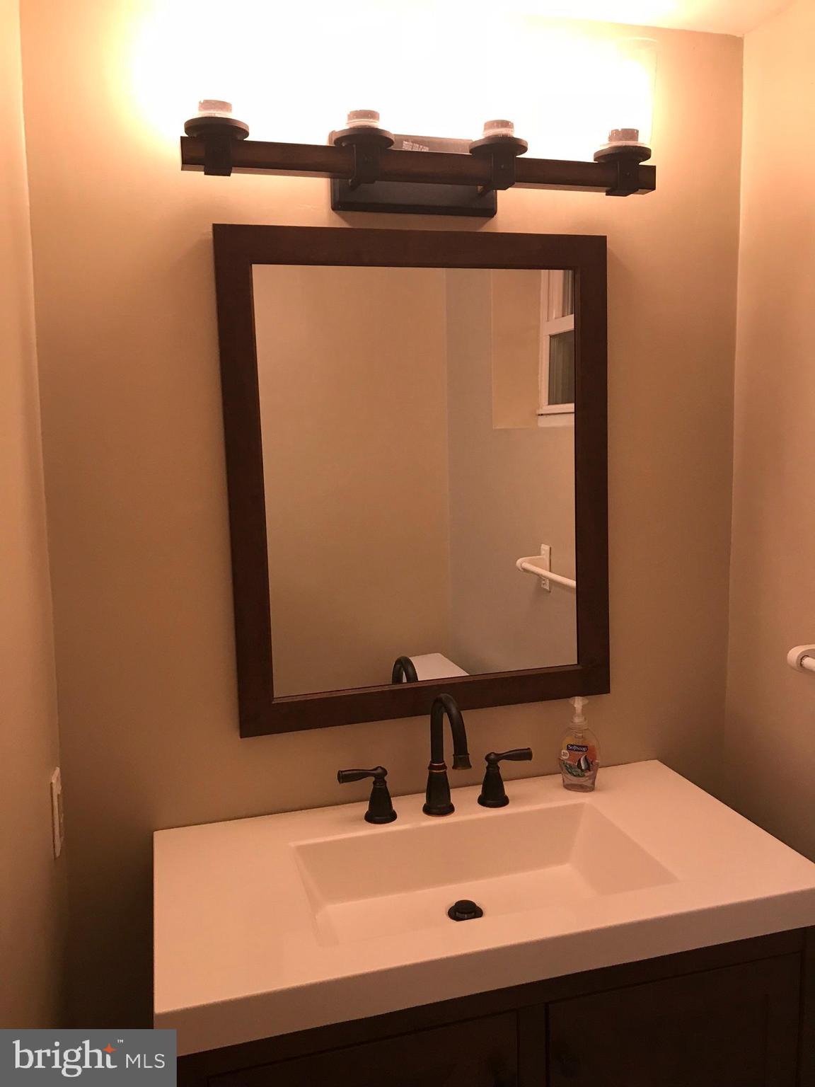 1458 Riverside Avenue, Unit 2B Baltimore, MD 21230 - Photo 13 of 16 a bathroom with a sink and a mirror