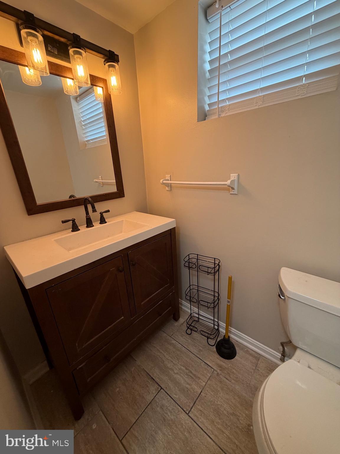 1458 Riverside Avenue, Unit 2B Baltimore, MD 21230 - Photo 15 of 16 a bathroom with a sink toilet and mirror