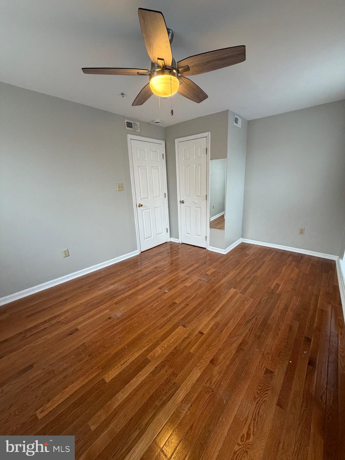 1458 Riverside Avenue, Unit 2B Baltimore, MD 21230 - Photo 9 of 16 a bedroom with a bed and a chandelier