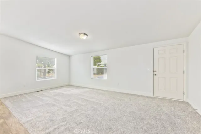 an empty room with a empty space and windows