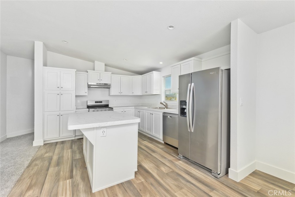 15252 Seneca Road, Unit 167 Victorville, CA 92394 - Photo 3 of 7 a kitchen with white cabinets and stainless steel appliances