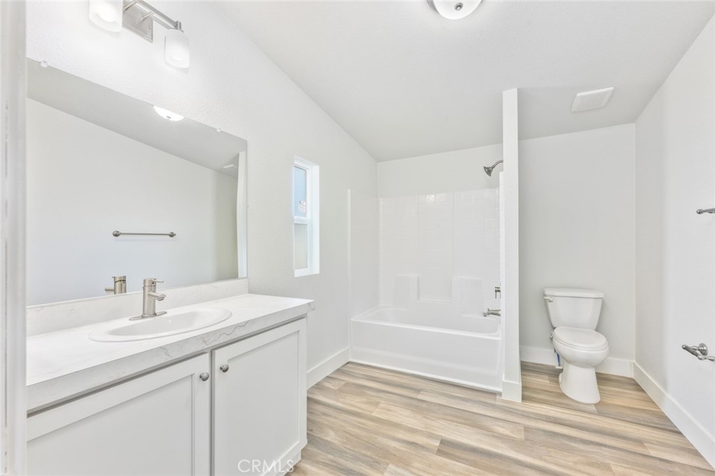 15252 Seneca Road, Unit 167 Victorville, CA 92394 - Photo 6 of 7 a bathroom with a sink a toilet and shower