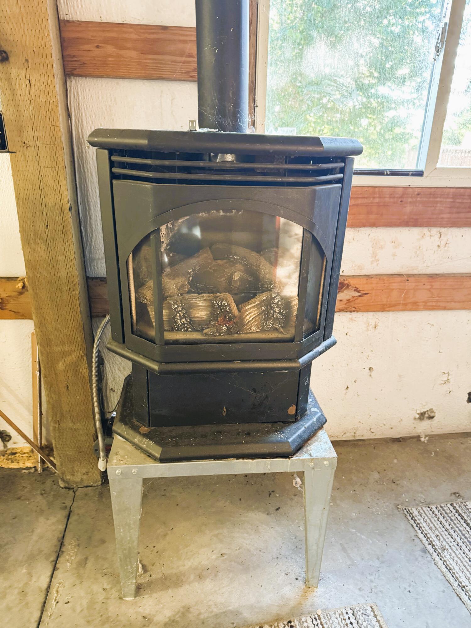 39030 Modoc Point Road Chiloquin, OR 97624 - Photo 29 of 37 woodstove inside shop/garage
