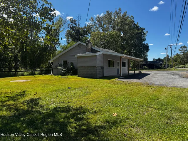 a house view with swimming pool in front of it