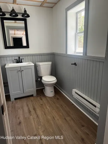 a bathroom with a toilet sink and mirror