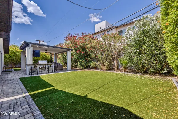 a view of a patio with a table and chairs