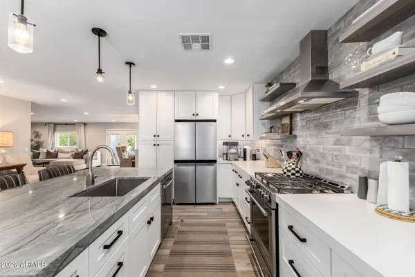 a kitchen with a sink stove and refrigerator