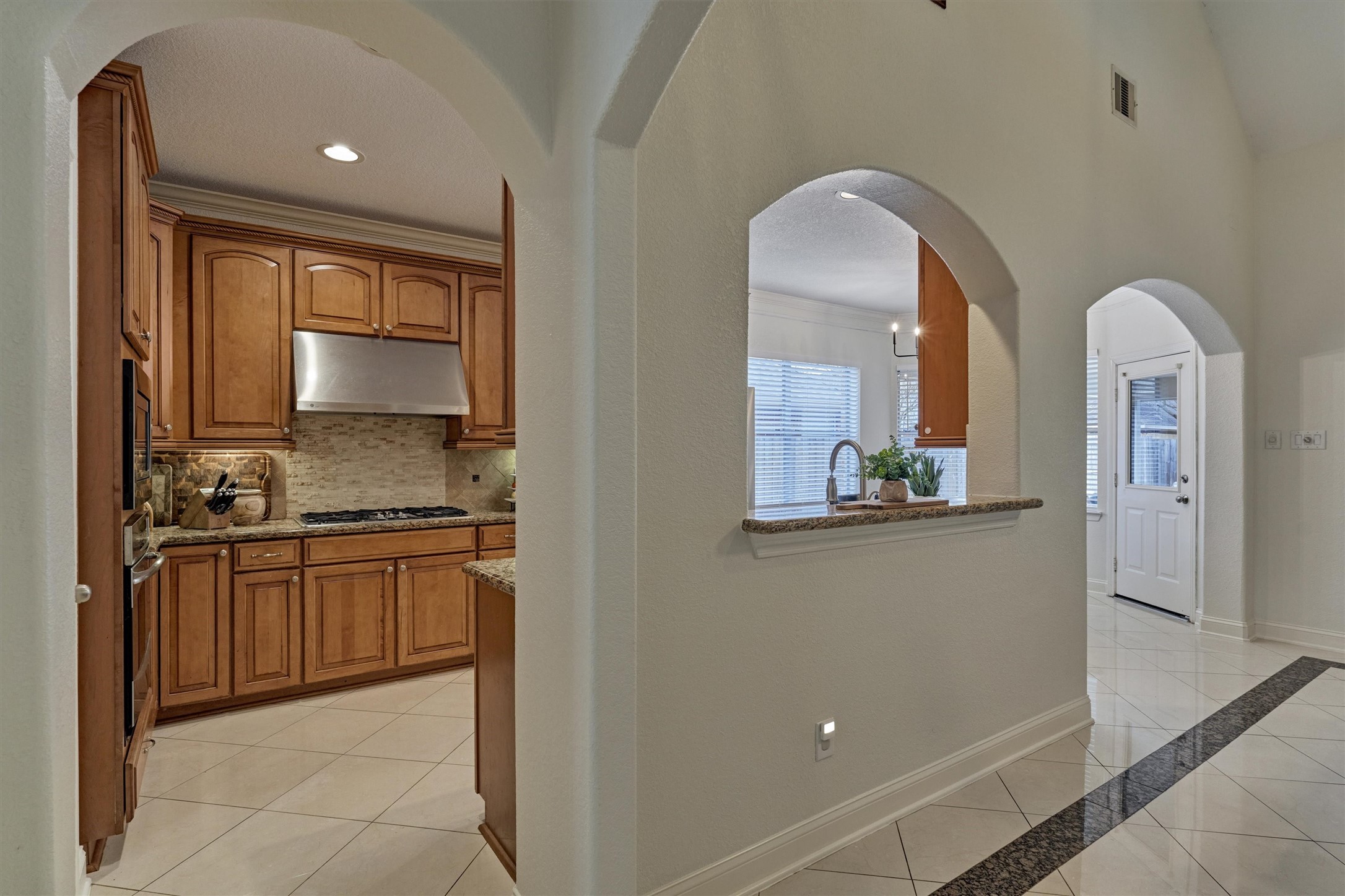 20938 Thistleberry Lane Spring, TX 77379 - Photo 12 of 45 Beautiful kitchen cabinets with pass-through window into Living Room.