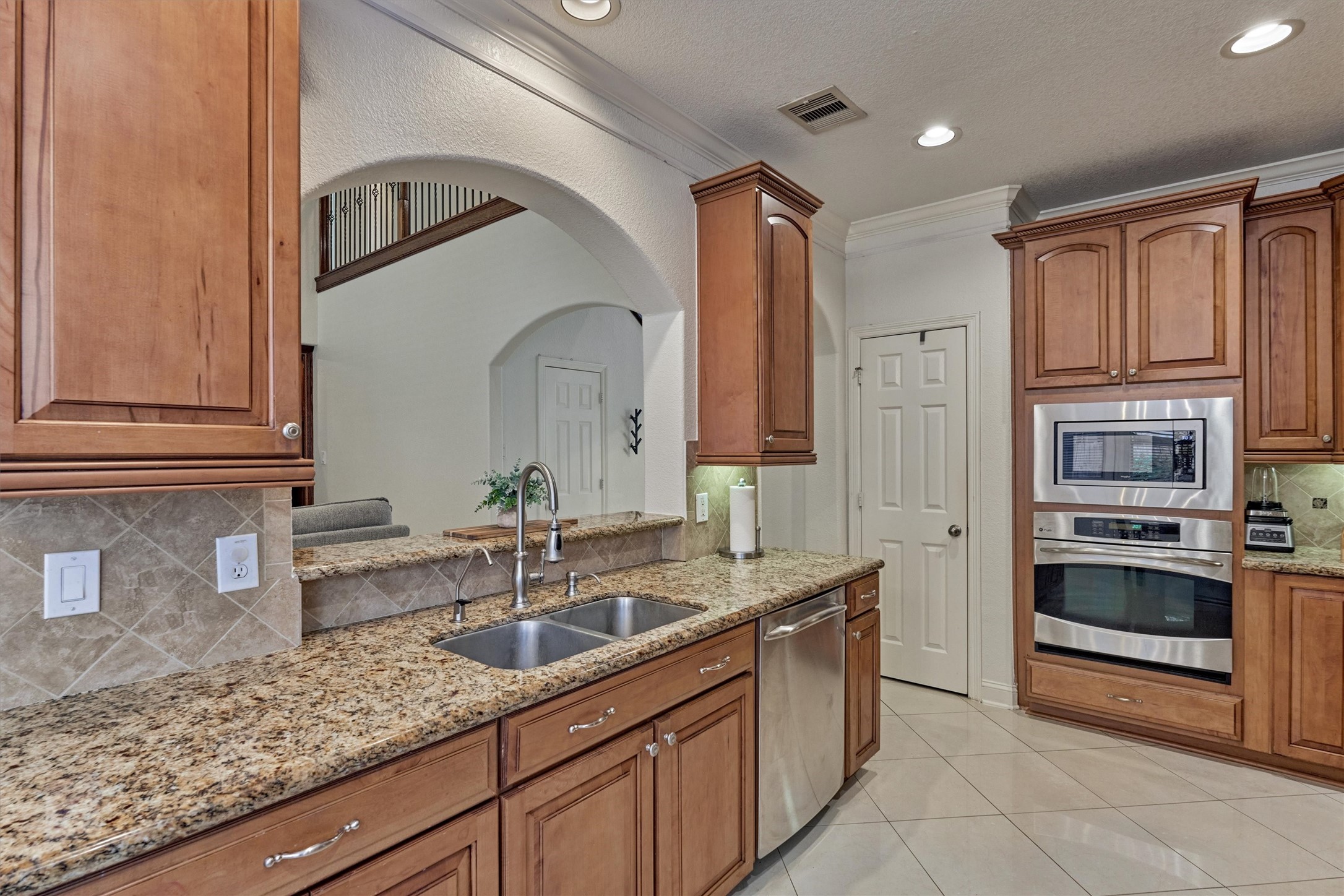 20938 Thistleberry Lane Spring, TX 77379 - Photo 13 of 45 Built-in electric oven and microwave. Sink at pass-through allows for continued conversations with guests in Living Room.