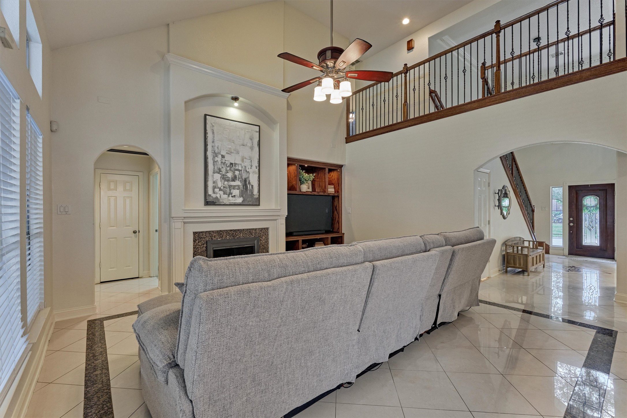 20938 Thistleberry Lane Spring, TX 77379 - Photo 18 of 45 Living room open to cat-walk upstairs, built-in for media, gas log fireplace and soaring ceilings.