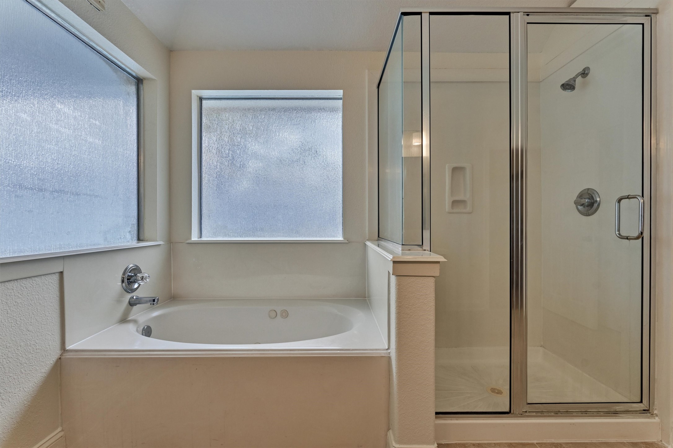 20938 Thistleberry Lane Spring, TX 77379 - Photo 25 of 45 Primary bath with separate tub and shower. Two large windows allowing for natural lighting.