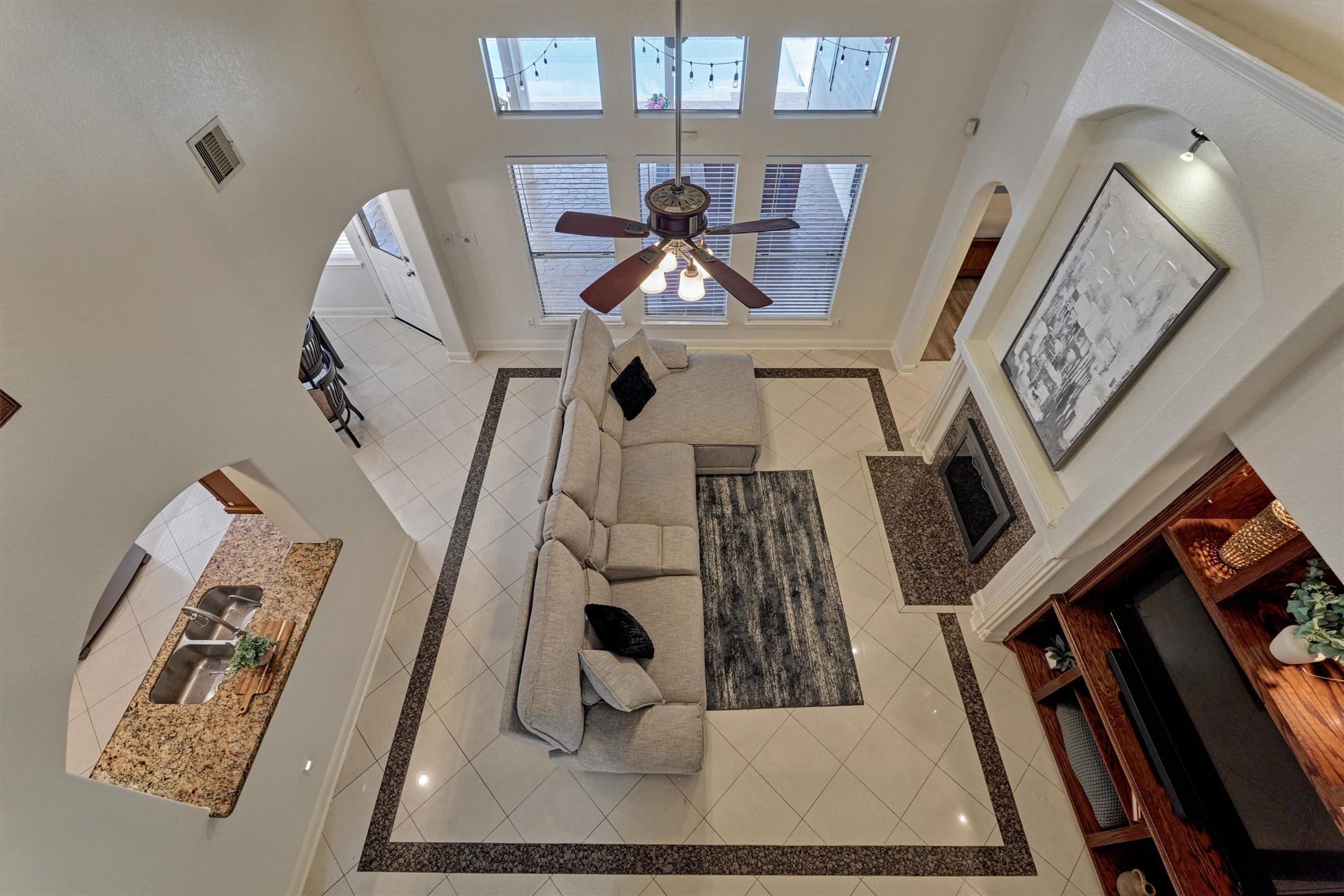 20938 Thistleberry Lane Spring, TX 77379 - Photo 27 of 45 View from upstairs cat-walk highlights the stunning tilework in Living Room.