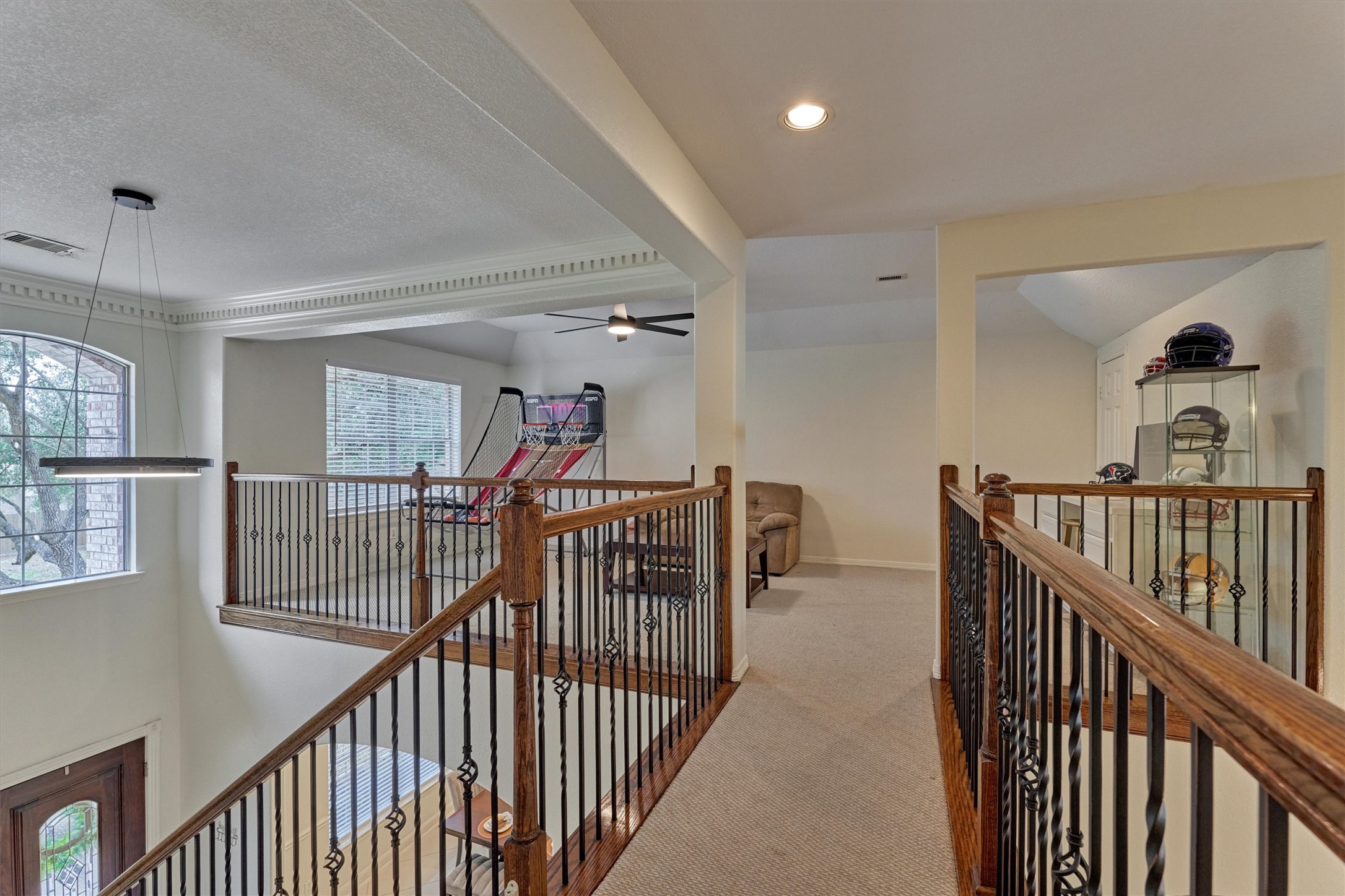20938 Thistleberry Lane Spring, TX 77379 - Photo 28 of 45 Upstairs walkway to Game Room. Beautiful stained wood with iron.