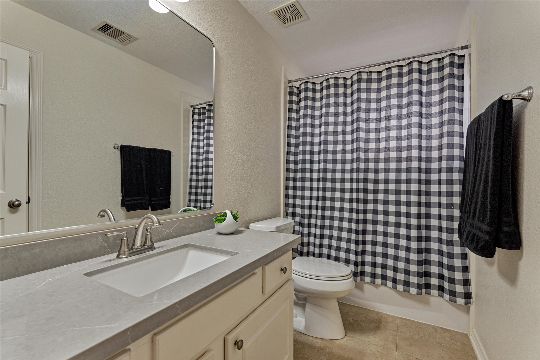 20938 Thistleberry Lane Spring, TX 77379 - Photo 35 of 45 Secondary Bathroom - upstairs with tub/shower combination. Linen closet in bathroom. Refreshed with quartz counter top, faucet, lighting and mirror.