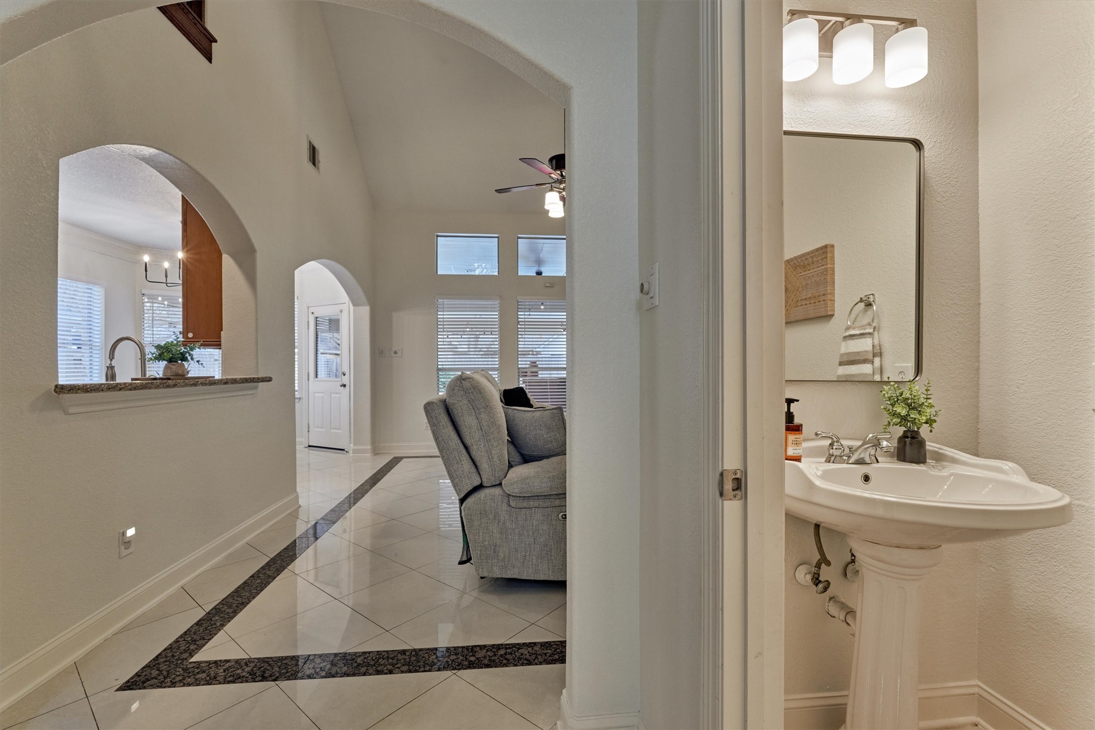 20938 Thistleberry Lane Spring, TX 77379 - Photo 10 of 45 View into Living Room from entry with Half Bath located on right (under stairs). Kitchen on left.