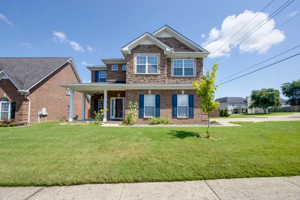 a front view of a house with a yard