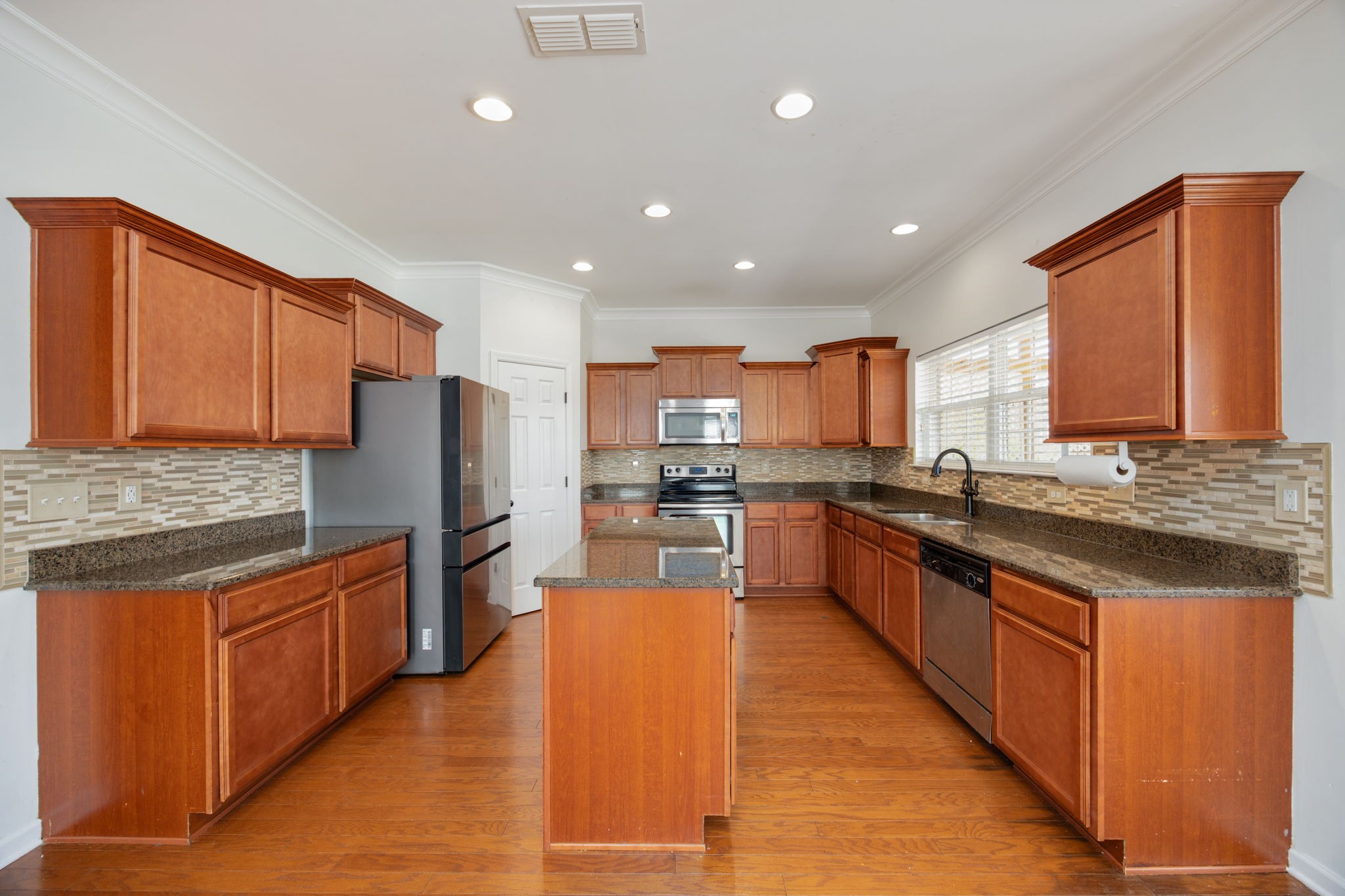 4093 Locerbie Circle Spring Hill, TN 37174 - Photo 17 of 51 a large kitchen with stainless steel appliances granite countertop a large counter top stainless steel appliances and cabinets