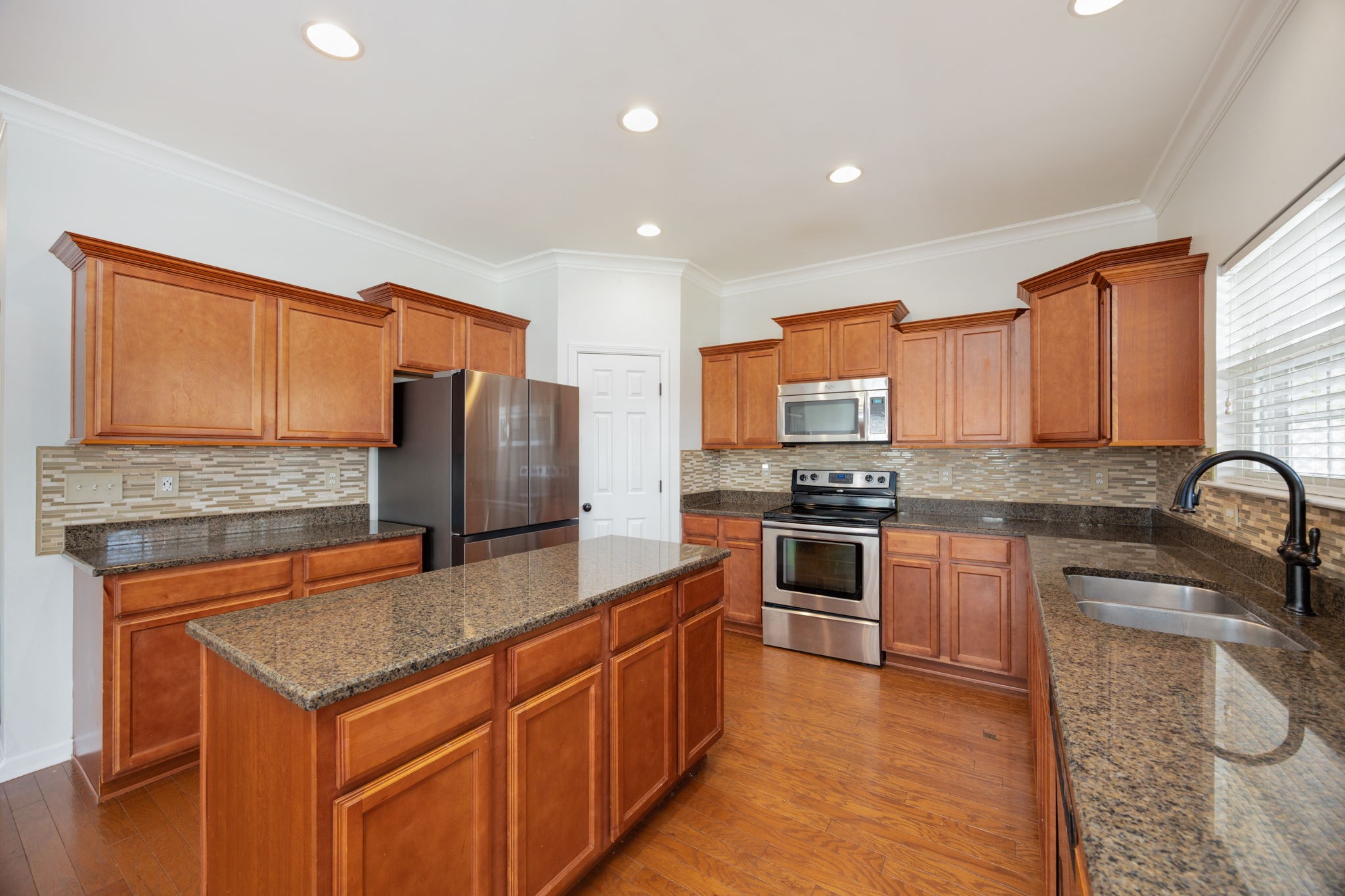 4093 Locerbie Circle Spring Hill, TN 37174 - Photo 18 of 51 a kitchen with stainless steel appliances granite countertop a stove top oven a sink and dishwasher