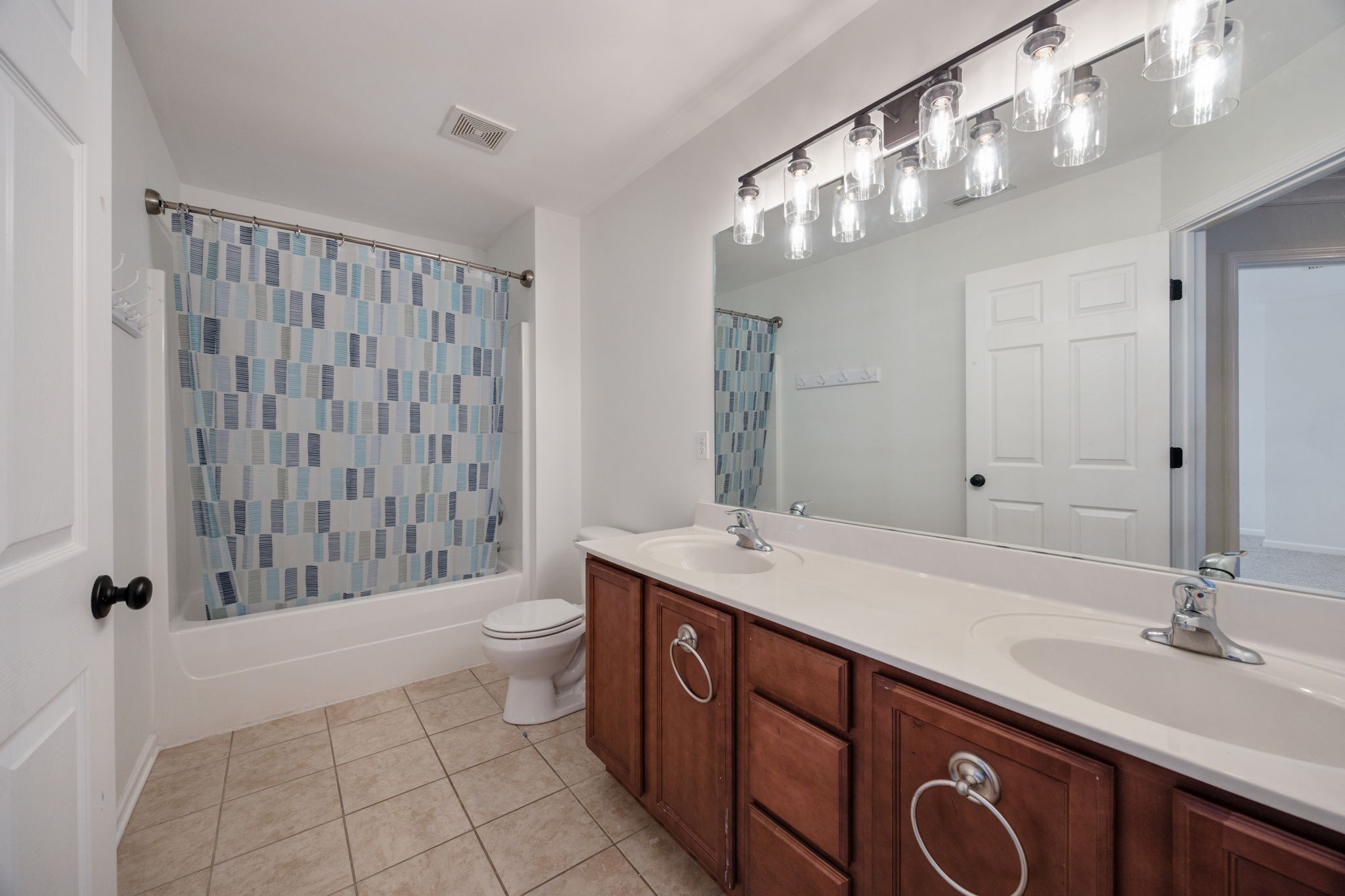 4093 Locerbie Circle Spring Hill, TN 37174 - Photo 22 of 51 a bathroom with a sink a toilet and a large mirror