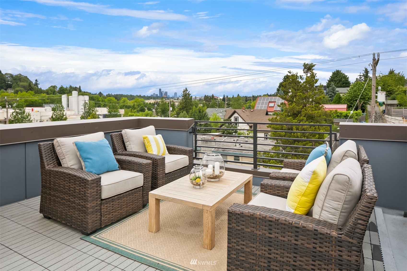 a view of roof deck with couches and city view