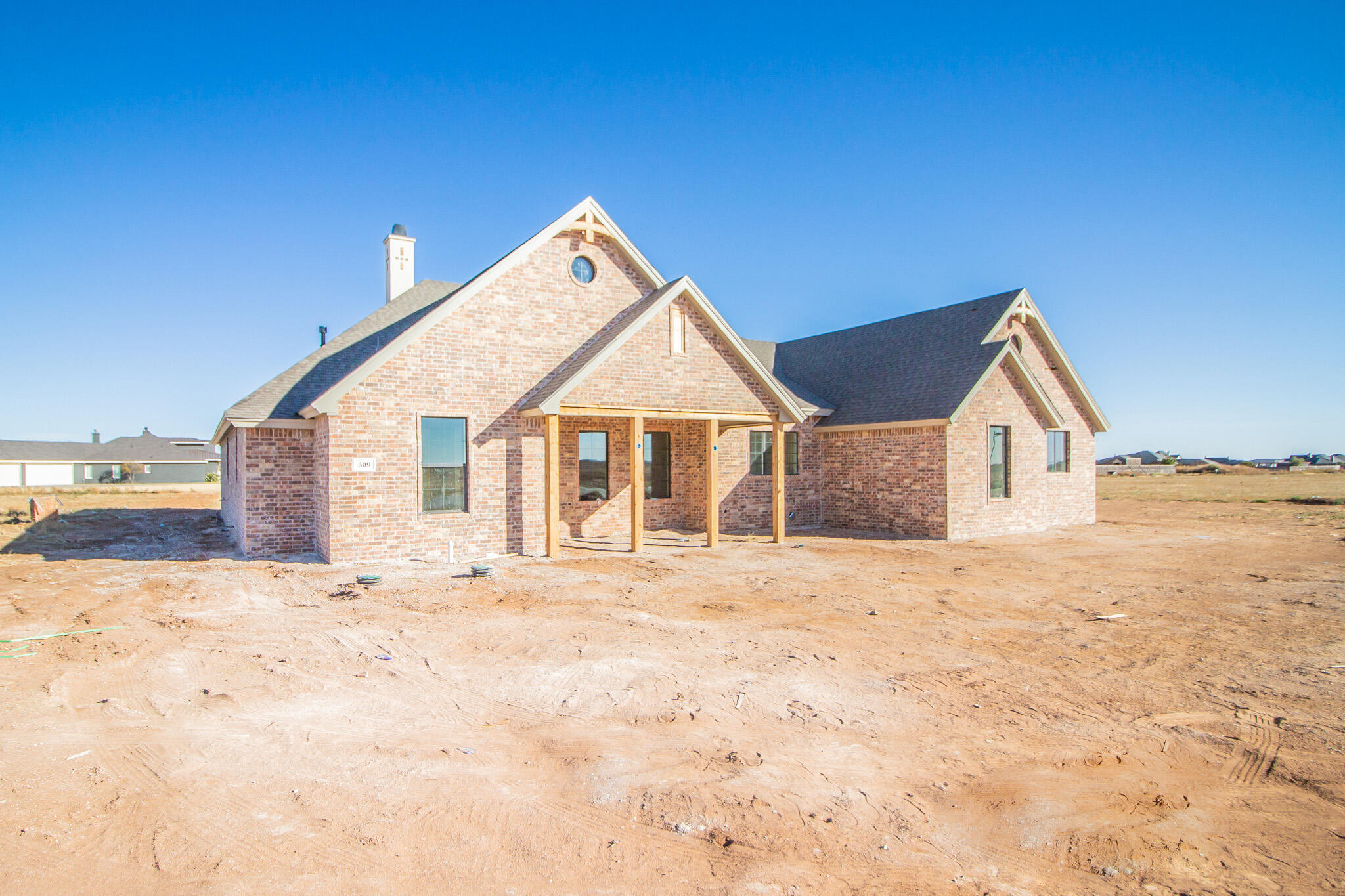 309 Juniper New Home, TX 79381 - Photo 2 of 24 a view of house with yard and hallway