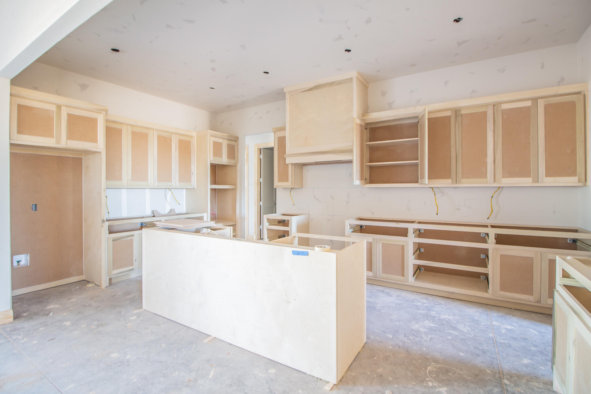 309 Juniper New Home, TX 79381 - Photo 10 of 24 a kitchen with a refrigerator and white cabinets