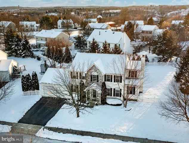 an aerial view of a house with yard and mountain view in back