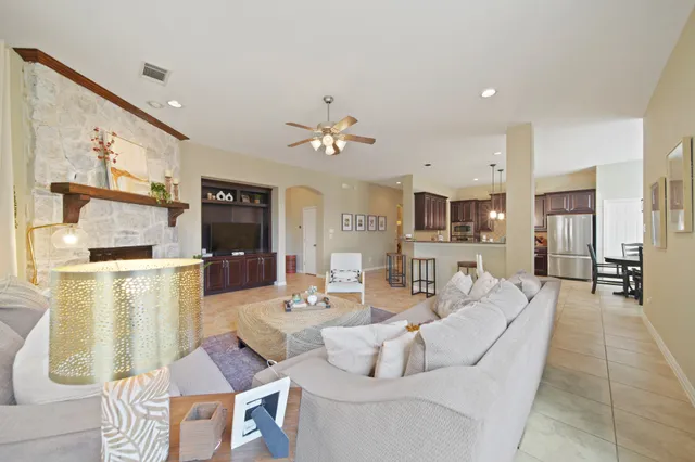 a spacious bedroom with a large bed and a chandelier