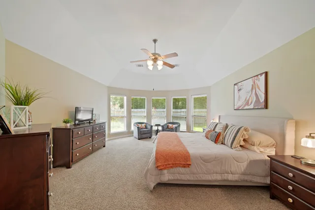 a bed room with a bed and a television