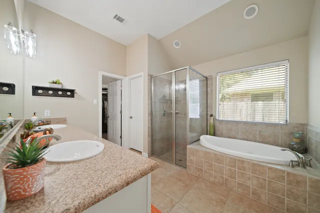 a bathroom with a double vanity sink mirror and shower
