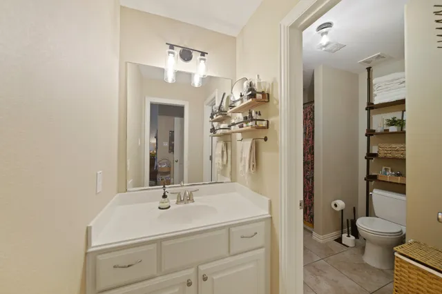 a bathroom with a double vanity sink mirror and shower