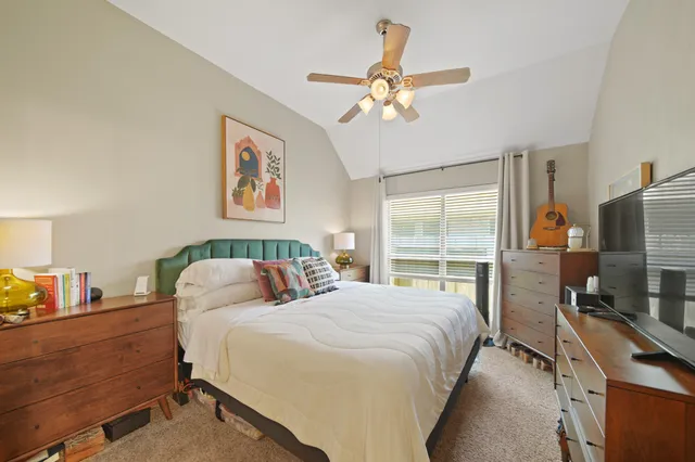 a bedroom with bed a table and chair