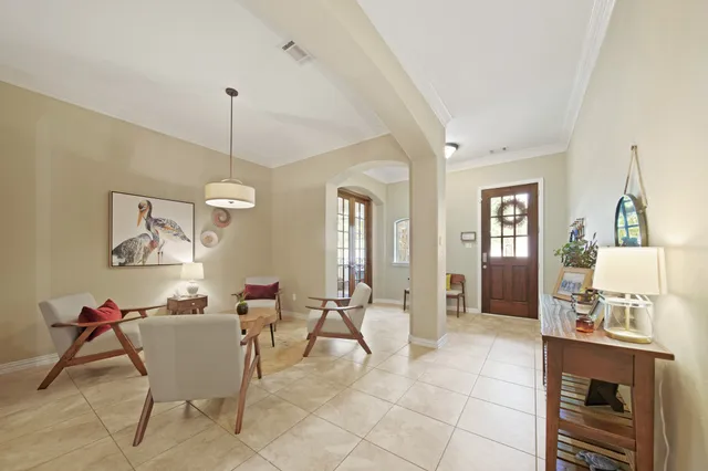 a living room with furniture and a dining table