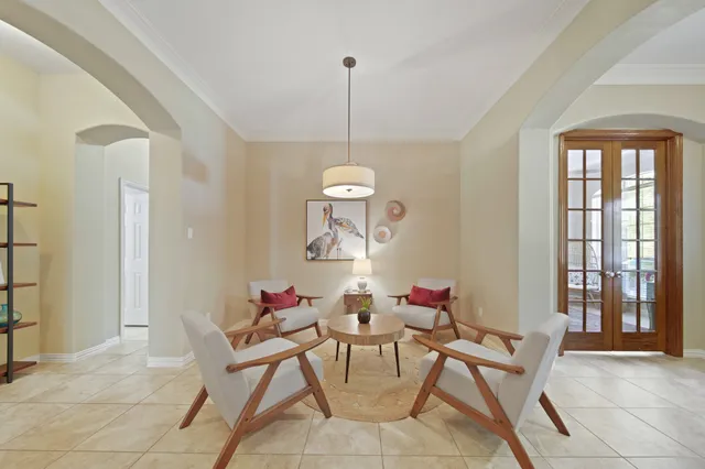 a dining room with furniture and a floor to ceiling window