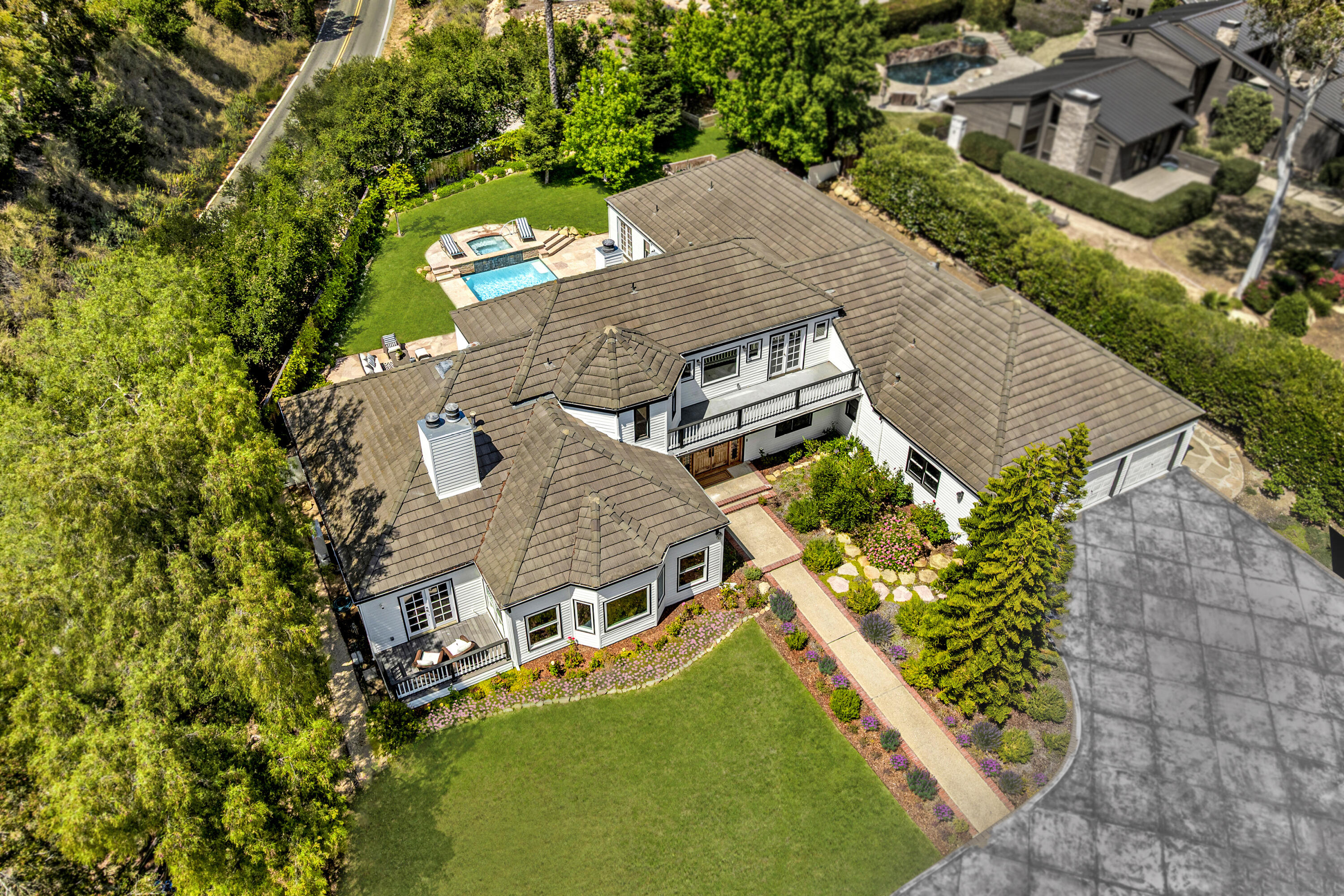 an aerial view of a house with a garden and swimming pool