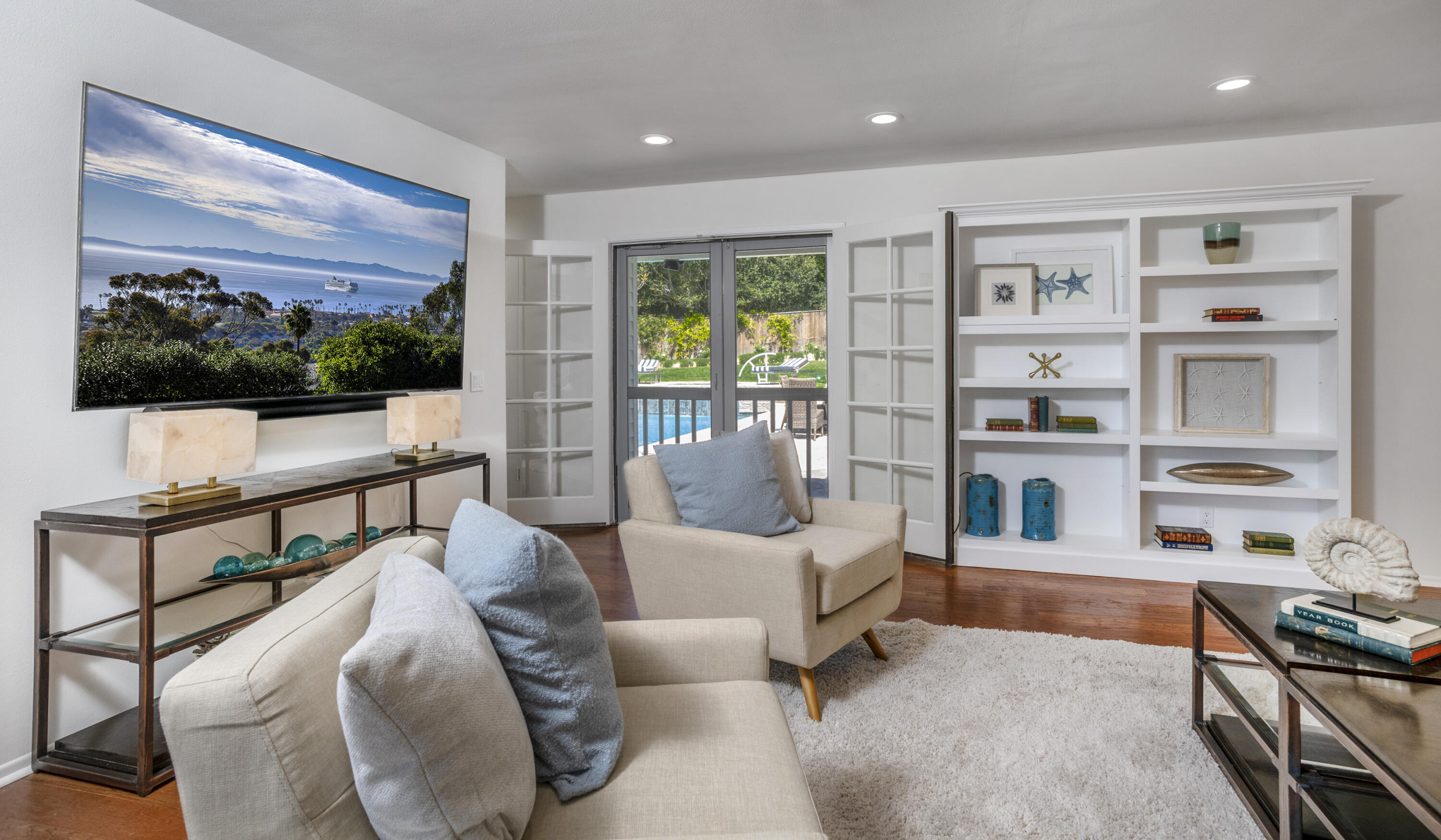 4530 Via Clarice Santa Barbara, CA 93111 - Photo 14 of 28 a living room with furniture flat screen tv and floor to ceiling window