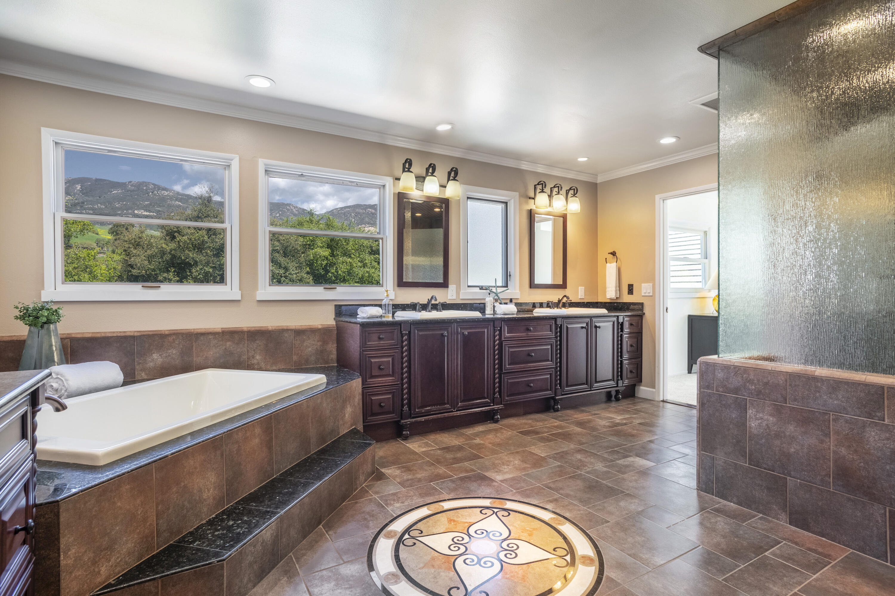 4530 Via Clarice Santa Barbara, CA 93111 - Photo 20 of 28 a bathroom with a tub a sink and a large mirror