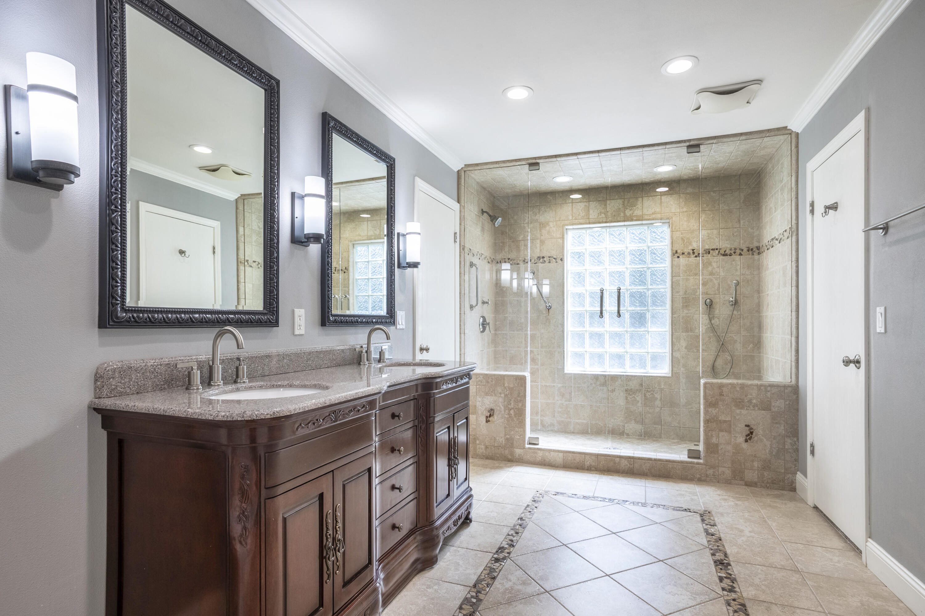 4530 Via Clarice Santa Barbara, CA 93111 - Photo 25 of 28 a bathroom with a granite countertop sink mirror and a shower