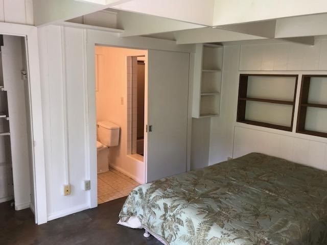 6050 Kapahi Road, Unit B Kapaa, HI 96746 - Photo 18 of 29 a bedroom with a bed and a mirror