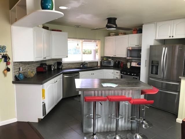 6050 Kapahi Road, Unit B Kapaa, HI 96746 - Photo 3 of 29 a kitchen with stainless steel appliances granite countertop a sink a stove and a refrigerator