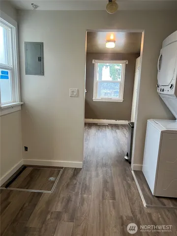 a view of a livingroom with wooden floor and a window