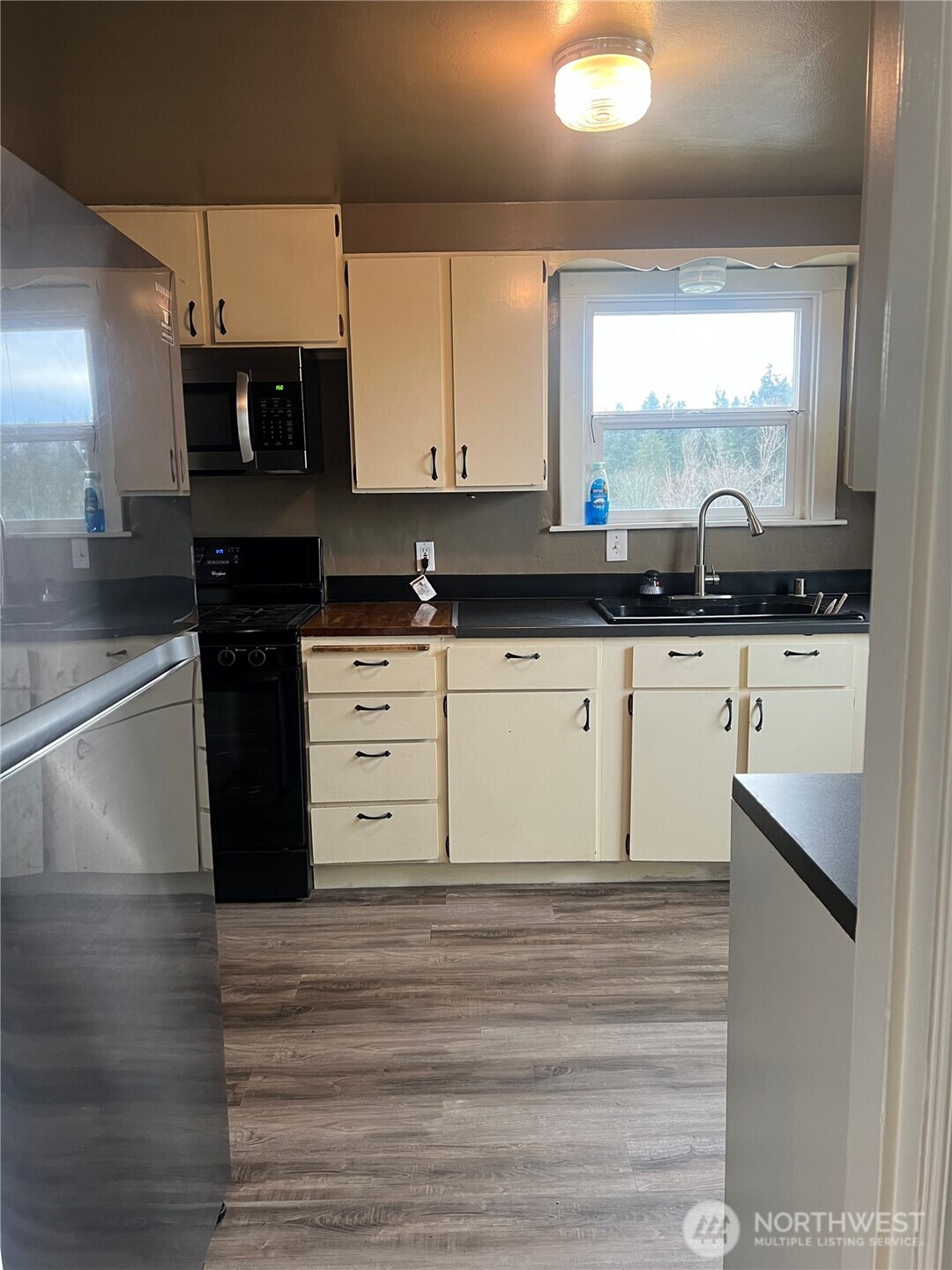 558 Windsor Place Northeast Renton, WA 98056 - Photo 14 of 20 a kitchen with stainless steel appliances granite countertop a stove a sink and a microwave