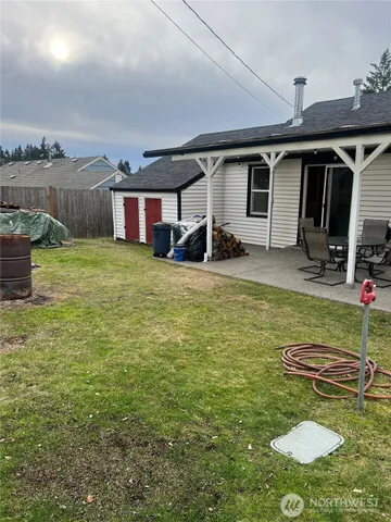 a view of a backyard with table and chairs