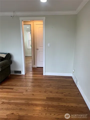 a view of wooden floor and cabinet in a room