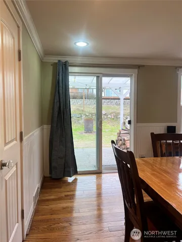 a view of a dining room with furniture and wooden floor