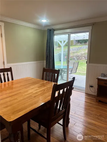 a view of a dining room with furniture window and wooden floor