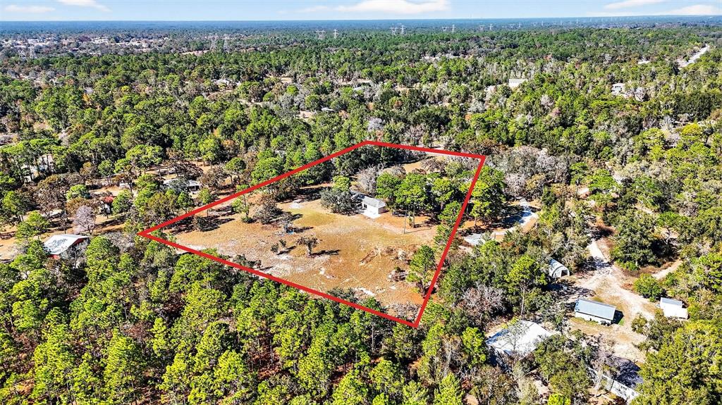 14252 Trinity Road Brooksville, FL 34614 - Photo 24 of 26 an aerial view of a houses with a yard