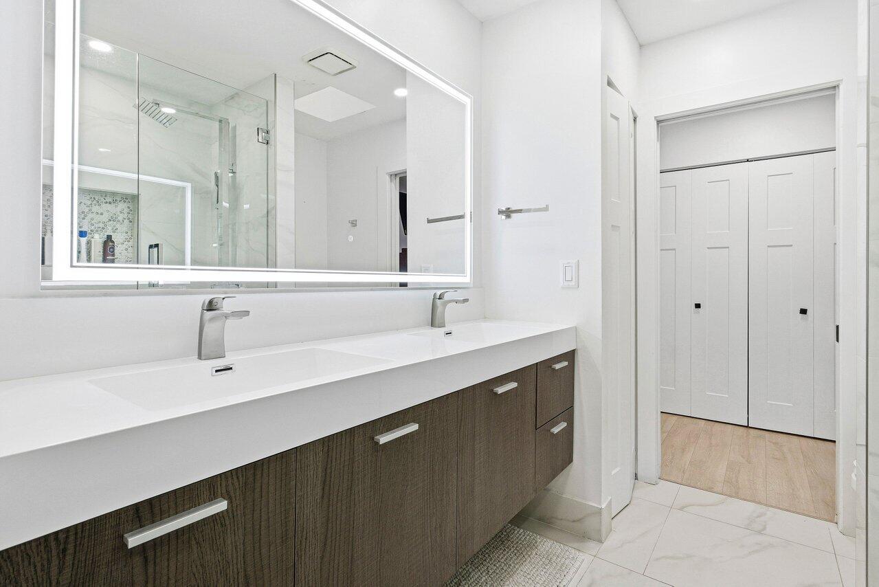 5696 Northwest 39th Avenue Boca Raton, FL 33496 - Photo 11 of 24 a bathroom with a sink vanity and mirror