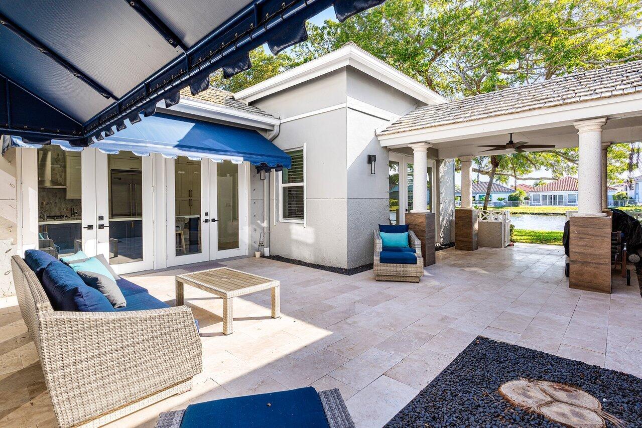 5696 Northwest 39th Avenue Boca Raton, FL 33496 - Photo 17 of 24 a view of a house with porch and furniture