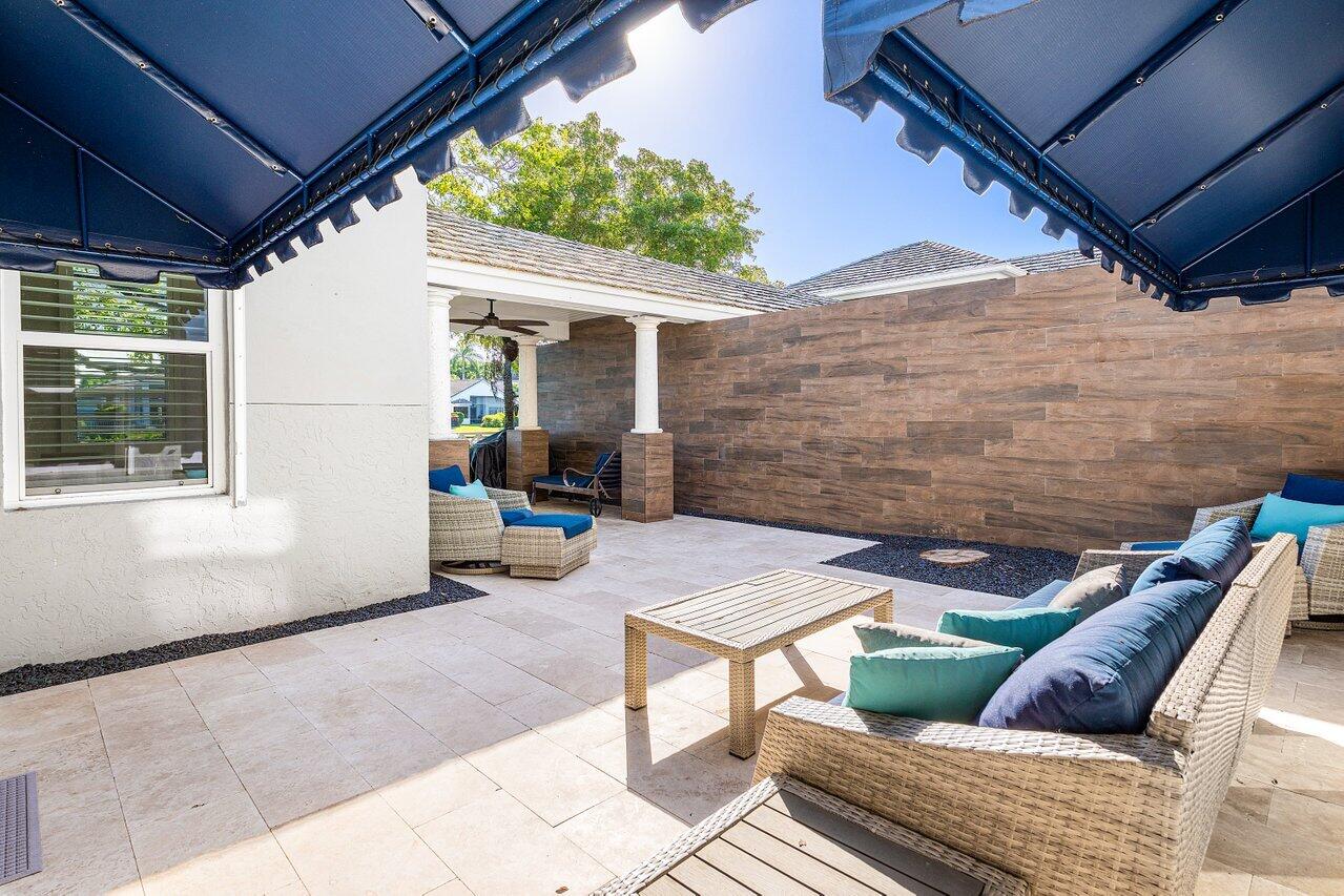 5696 Northwest 39th Avenue Boca Raton, FL 33496 - Photo 18 of 24 a backyard of a house with seating space